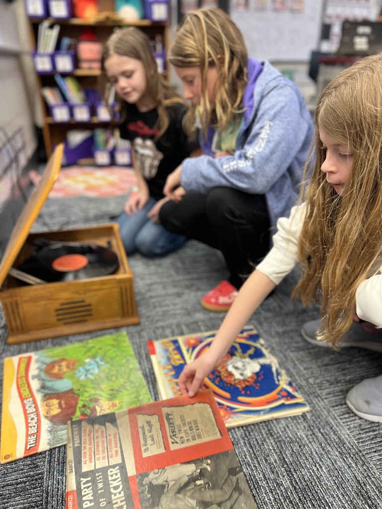 3 Students looking at records