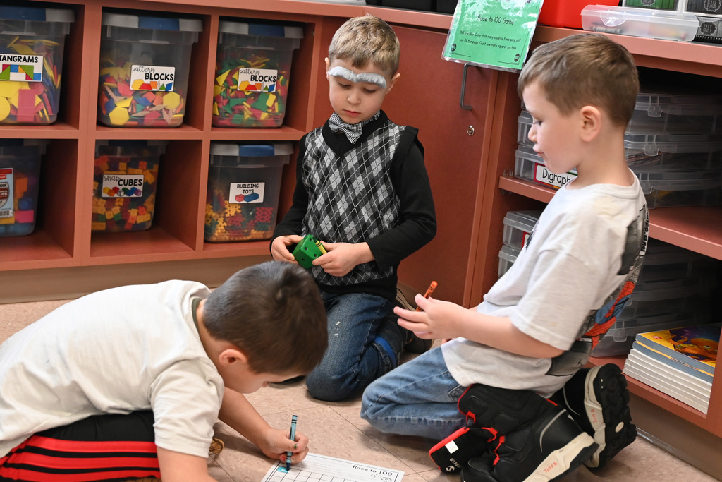 Three boys playing on dressed like old man