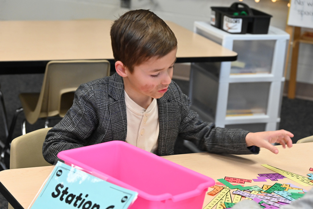 child dresses as old man using counting strips