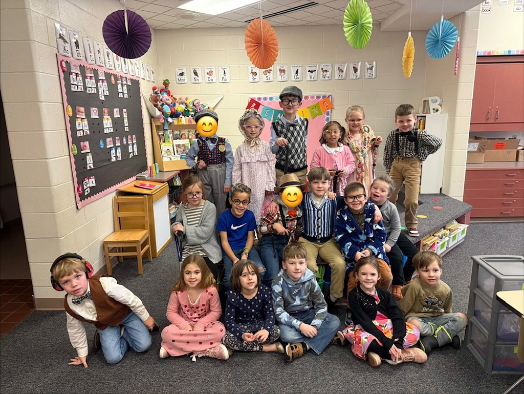 class of students, lined up posing for picture, dressed up for 100 day celebration