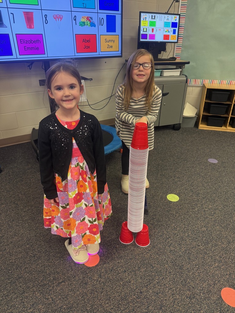 two girls making a cup rocket