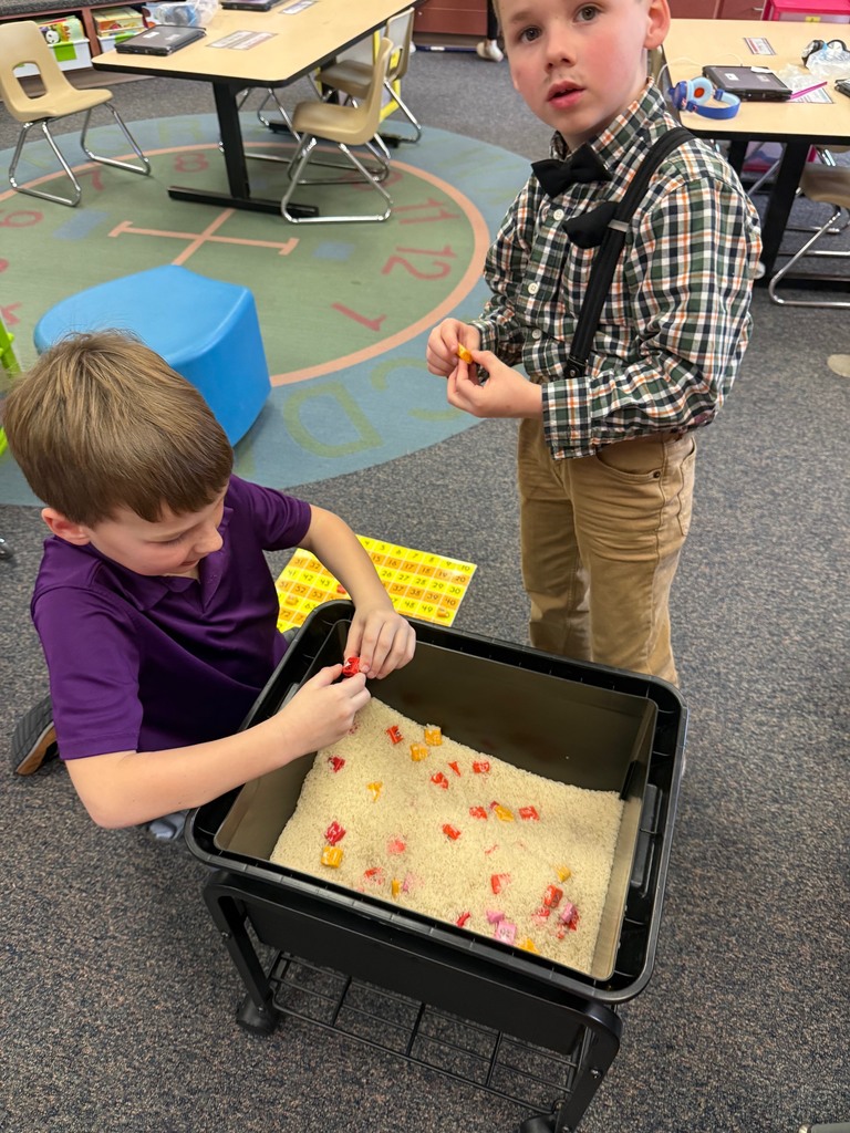 tow boys playing in bucket of rice
