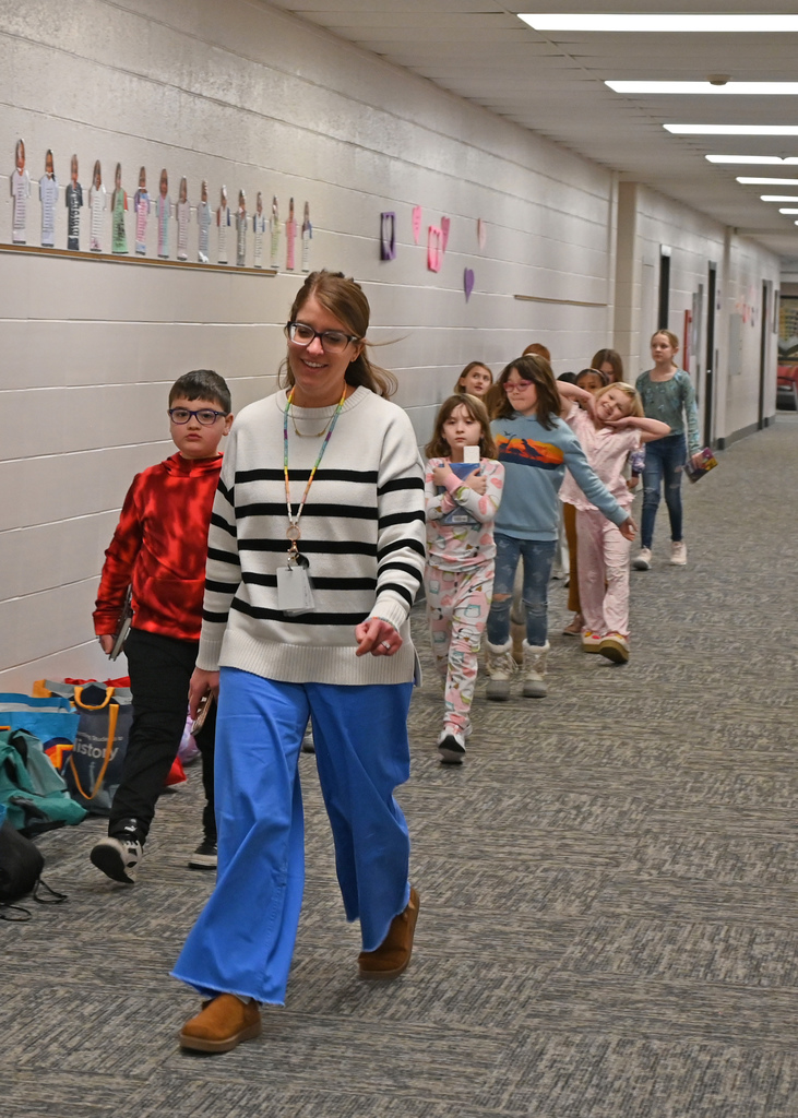 teacher and students walking down hall