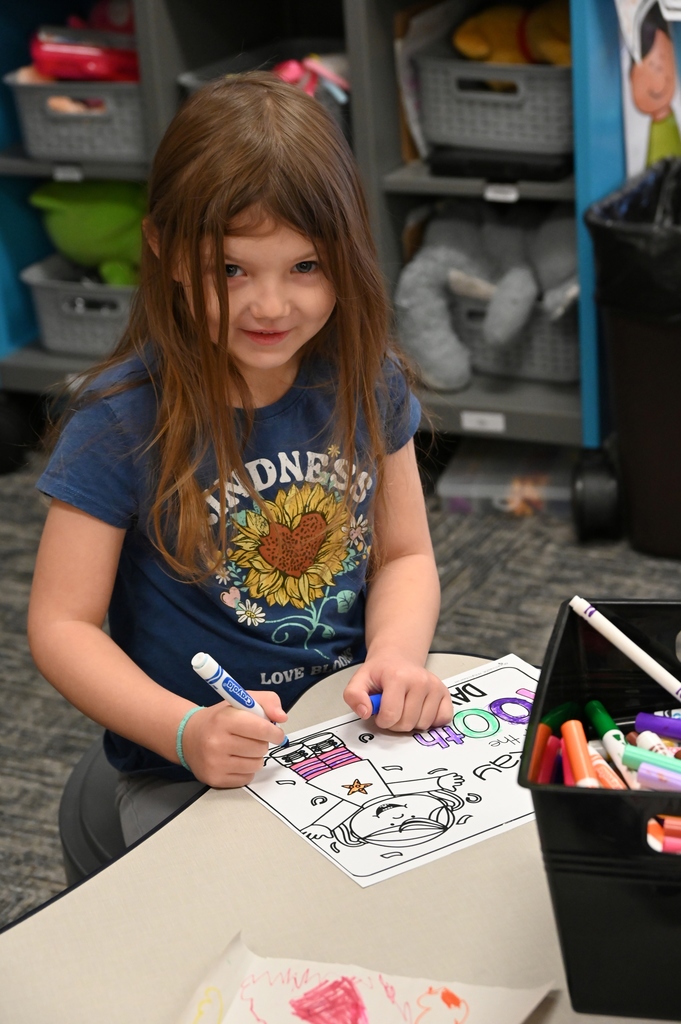 girl working on worksheet smiling