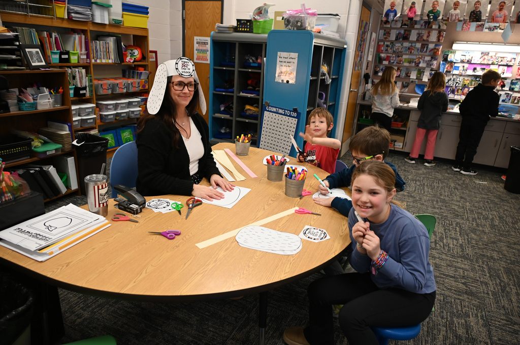 teacher at tavle with 3 students