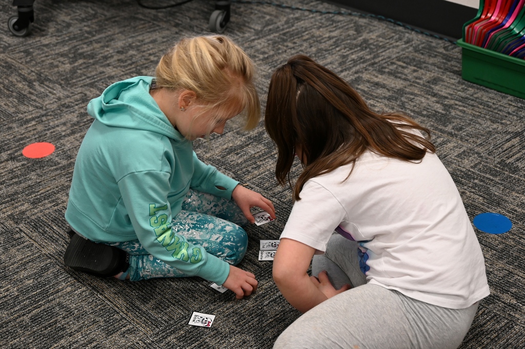 two girls workign with cards