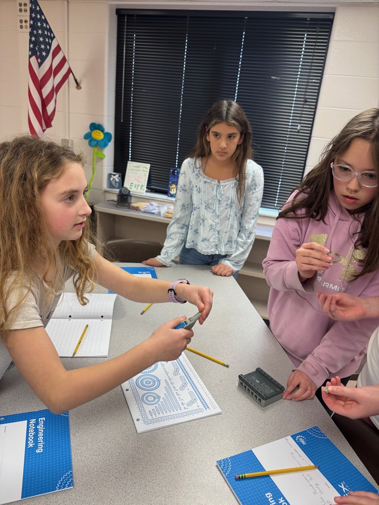 3 students working on robot components