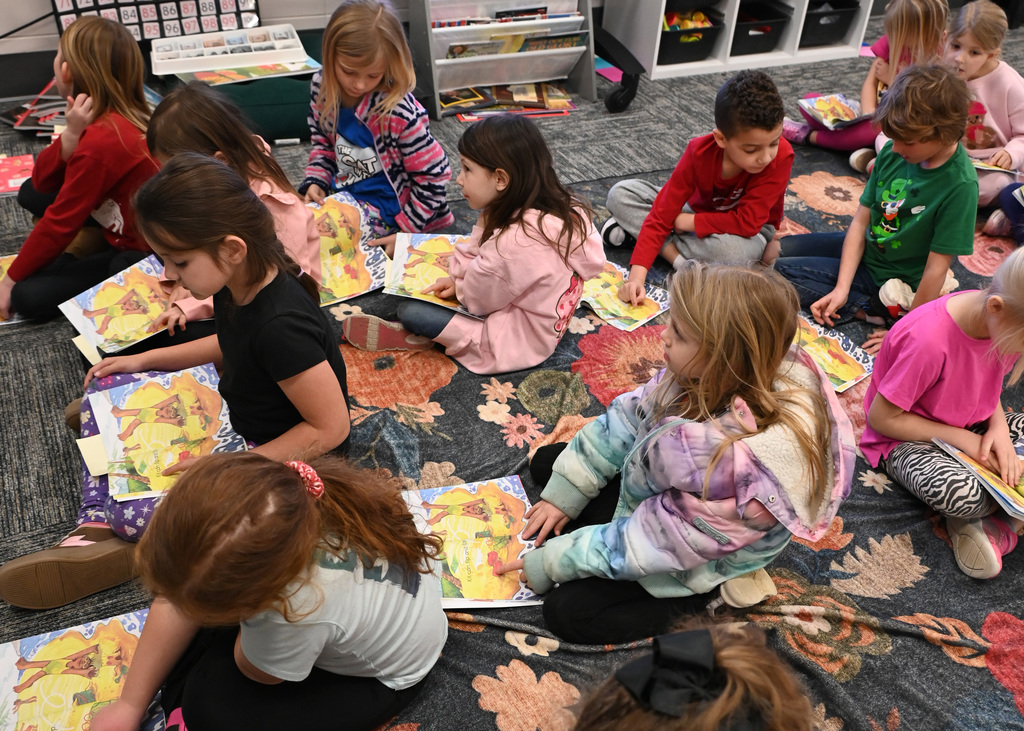 students sitting on floor reading