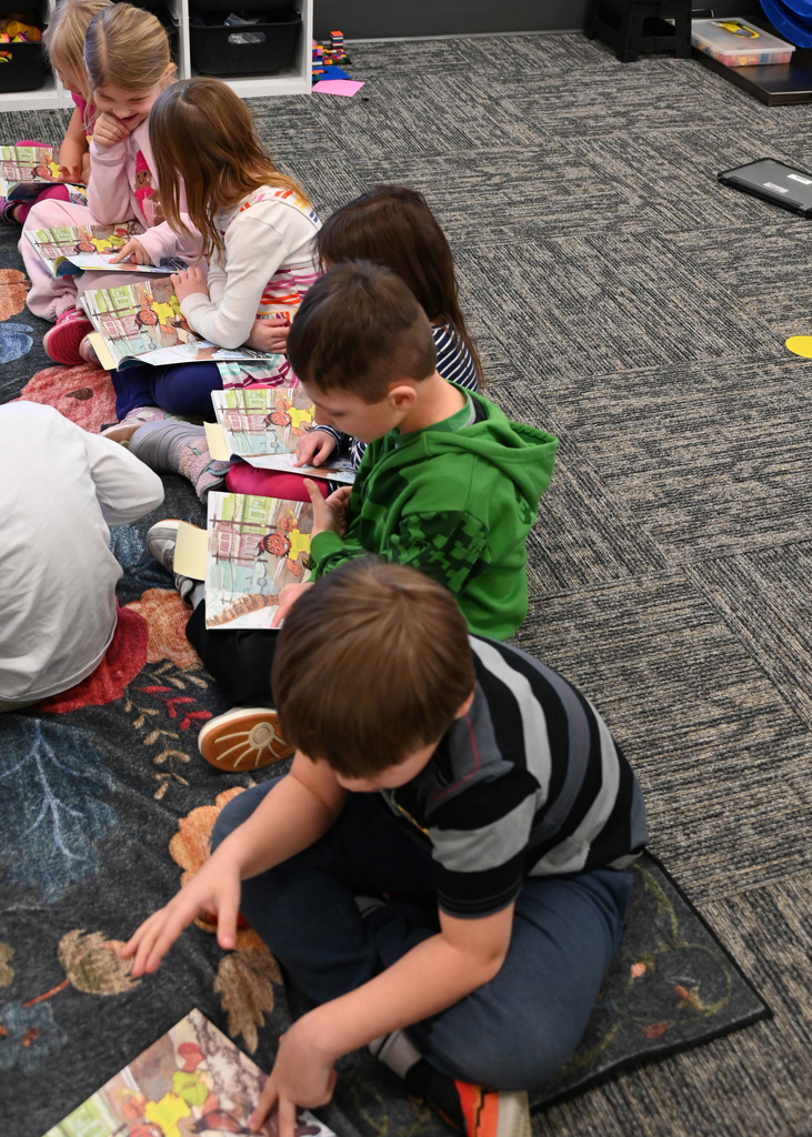 students sitting on floor reading
