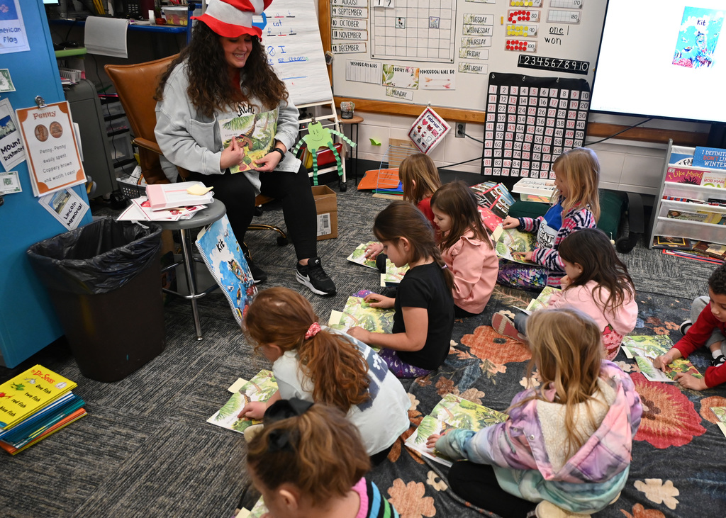 teacher reading to class of students