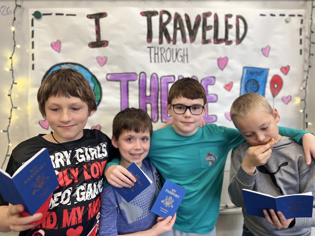 4 boys holding passports