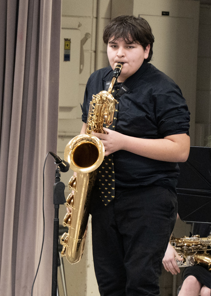 boy playing saxaphone