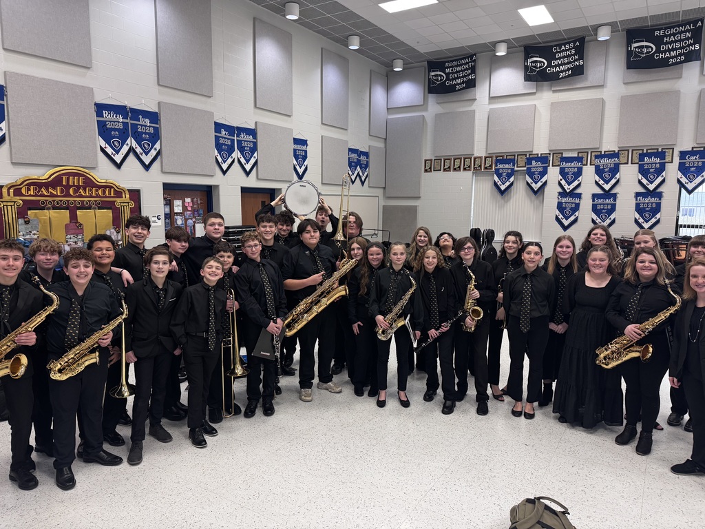 large group of middle schoolers dressed in black and holding instruments for a Jazz band competition
