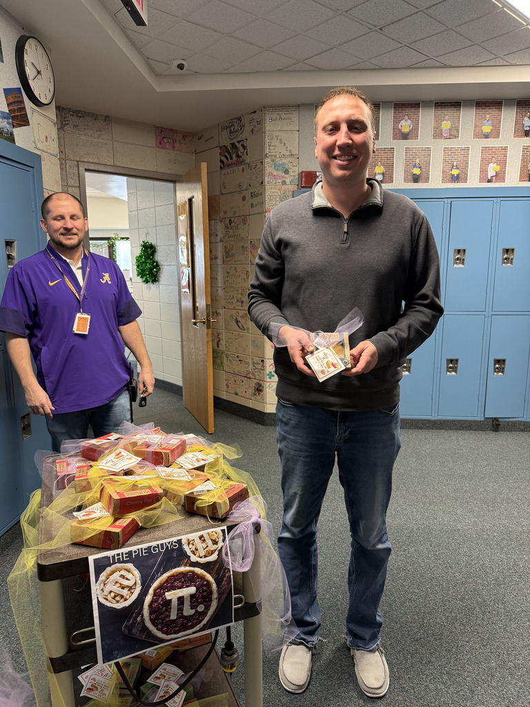 Two men by a cart one holding a small pie