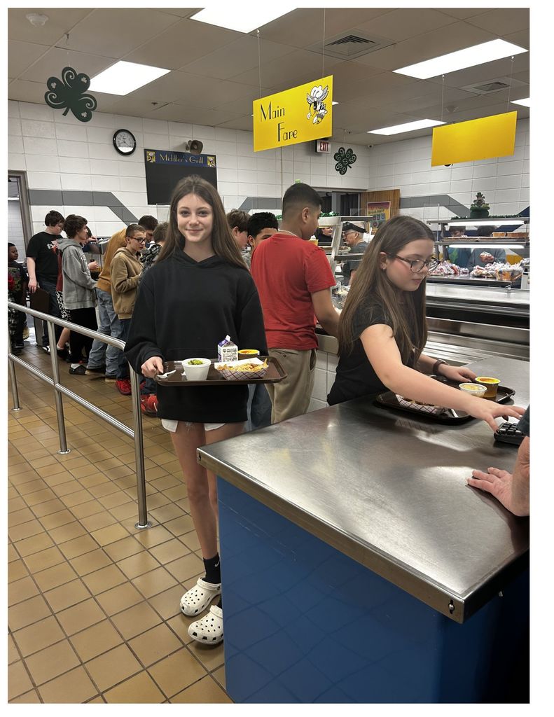 students carrying trays in a cafeteria