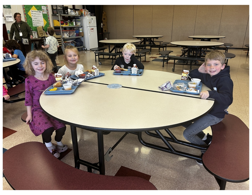 childern in a cafeteria eating lunch