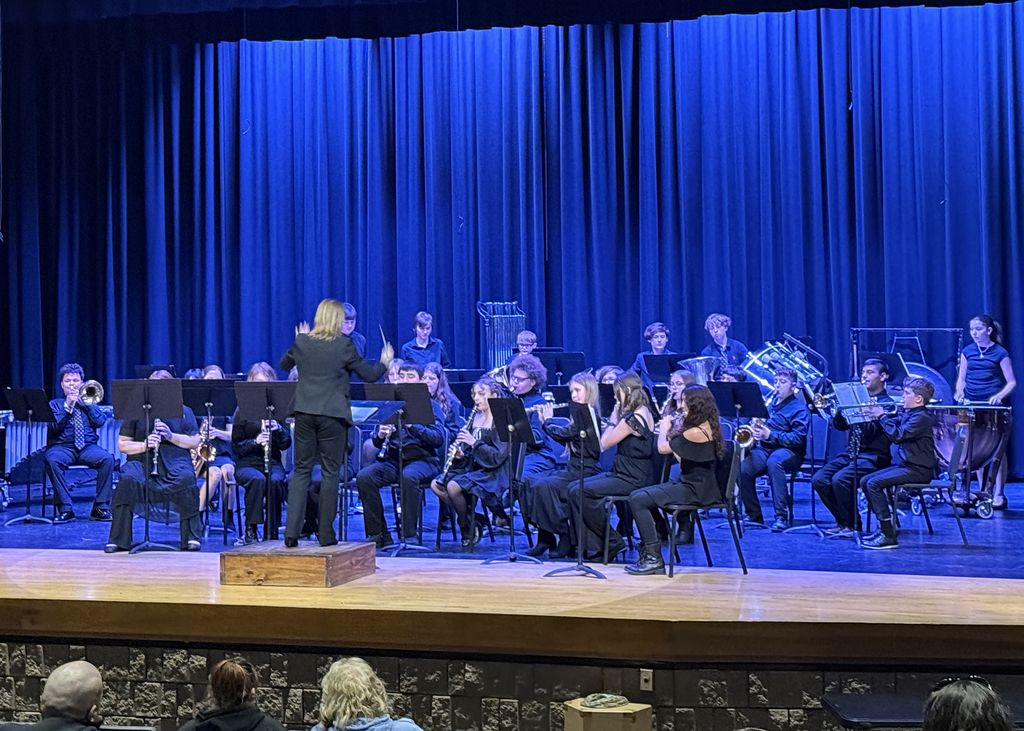 Middle school band on stage performing