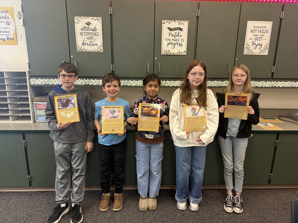 five 5th grade students holding self made pokemon cards