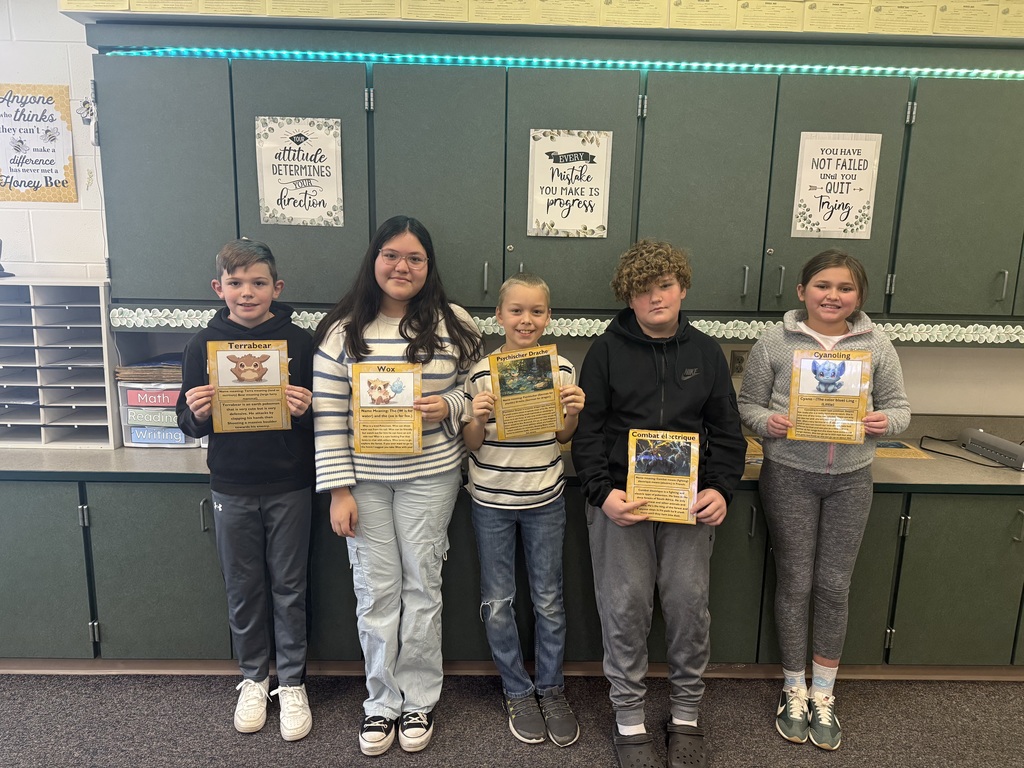 five 5th grade students holding self made pokemon cards