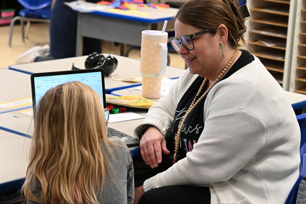 adult and child sitting looking at each other