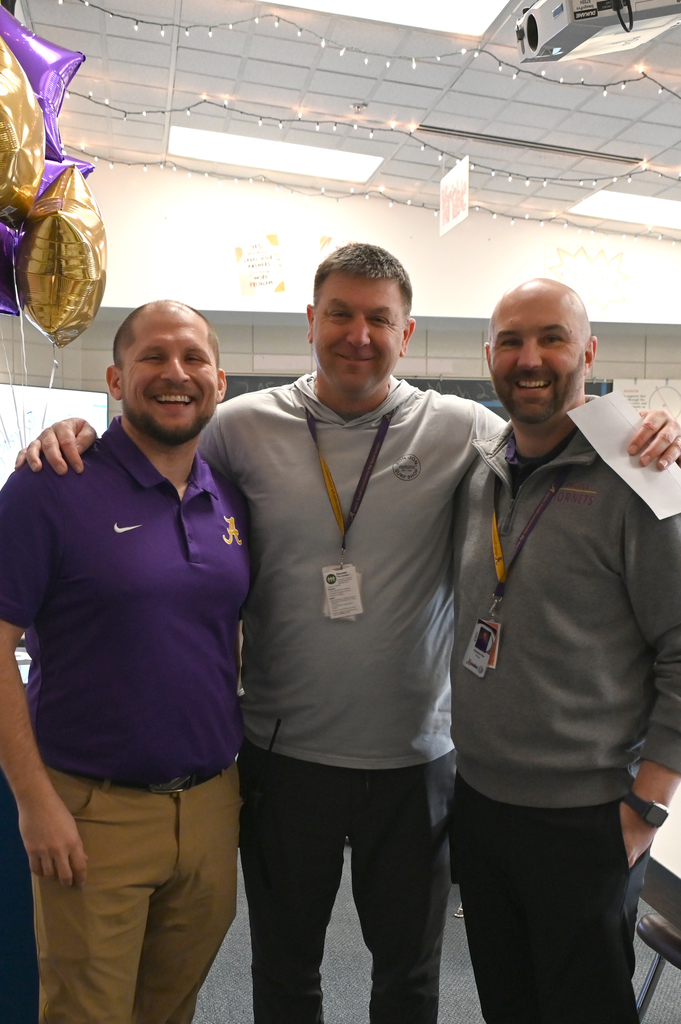 Three men smiling act camera arms around each other