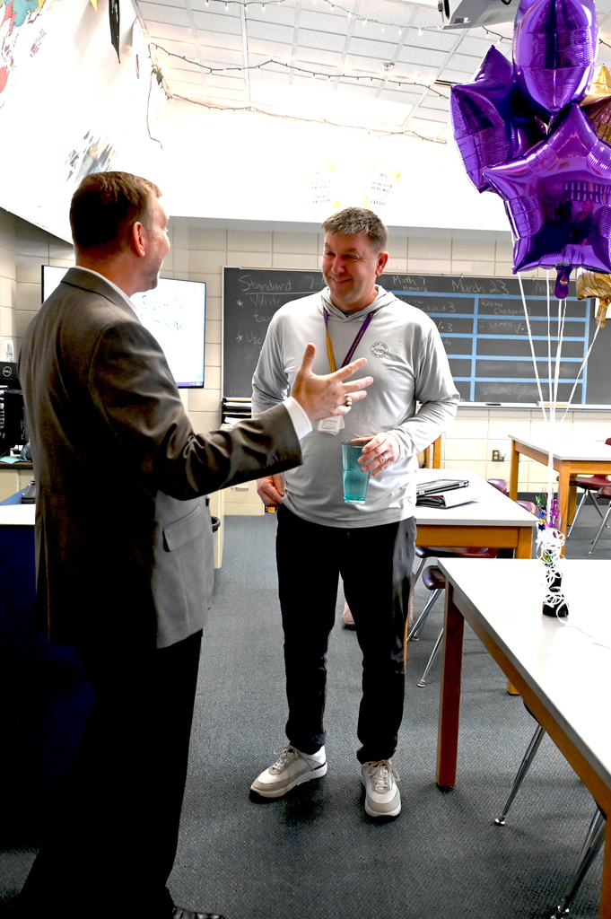 two men one man is reaching out to shake the other mans hand