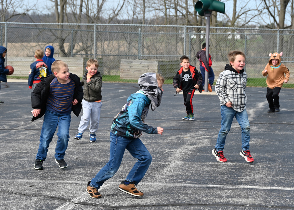 kids playing and running around playground