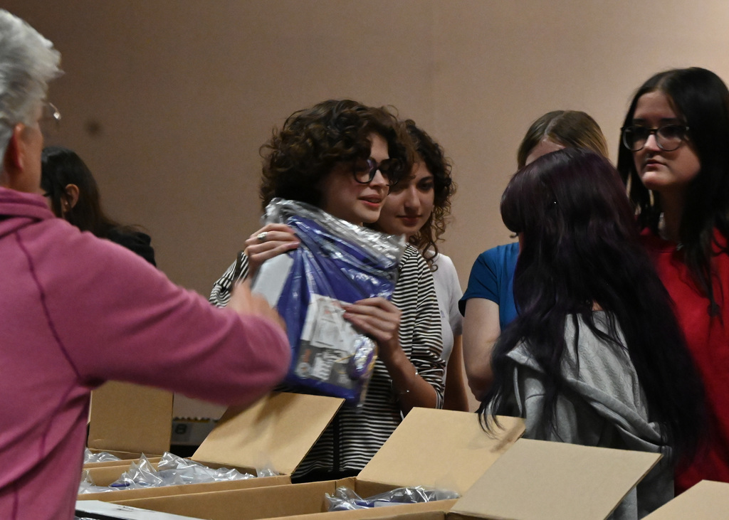 group of students holding packages