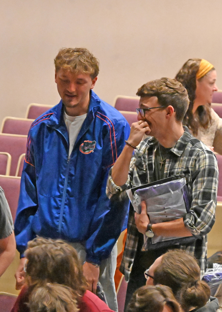 two teenagers standing talking