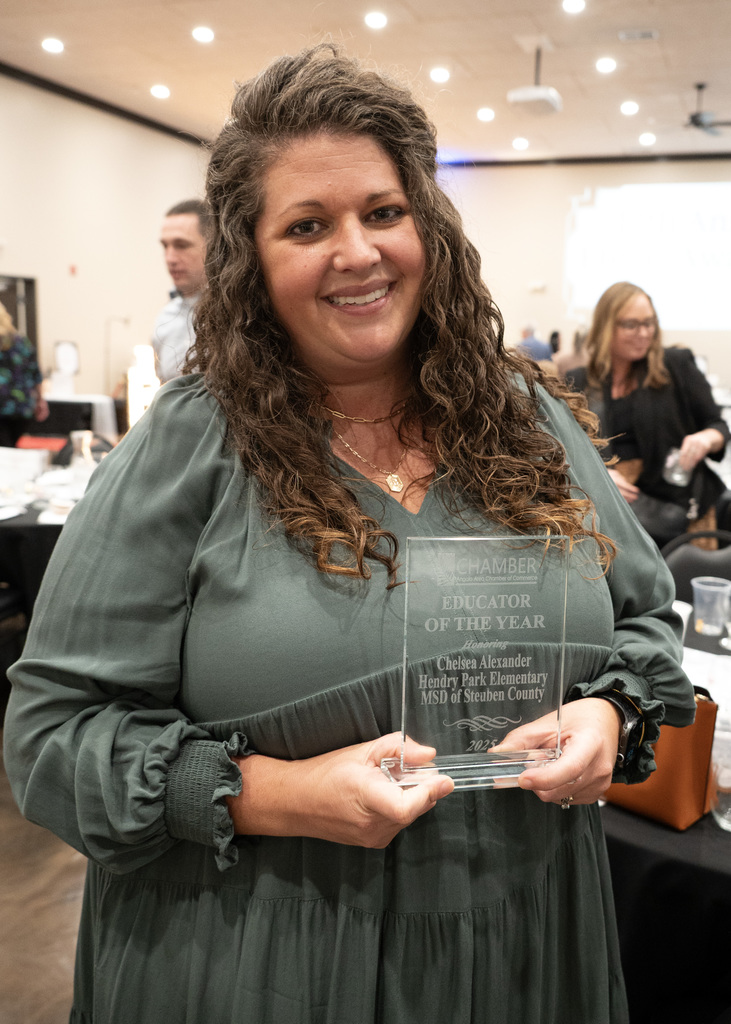 Women smiling holding award