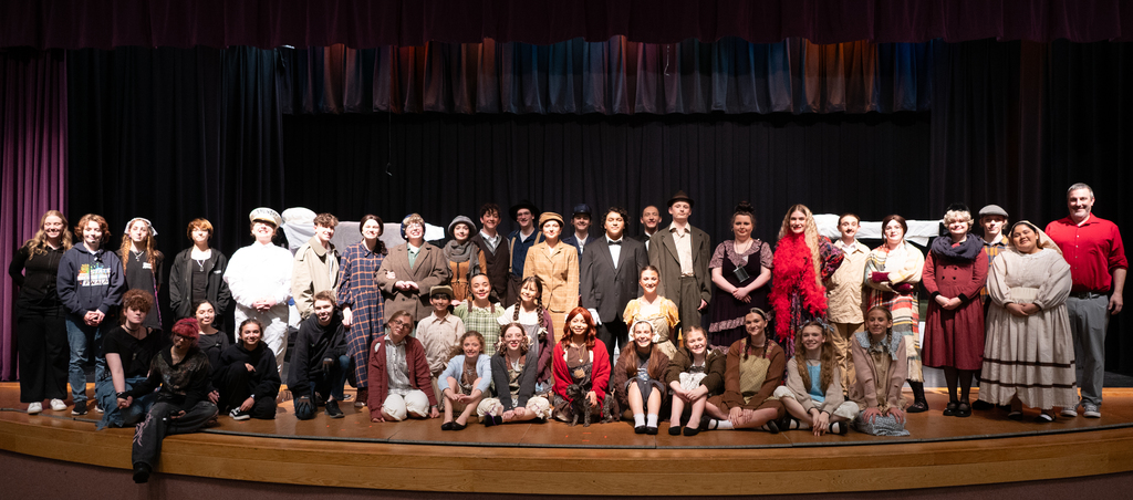 large cast of the stage show annie, all in costume from the 30's