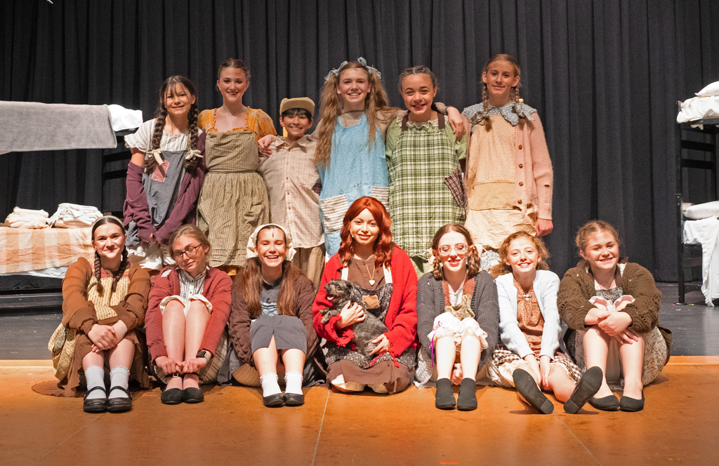 group of kids dressed as orphnas from the 30's