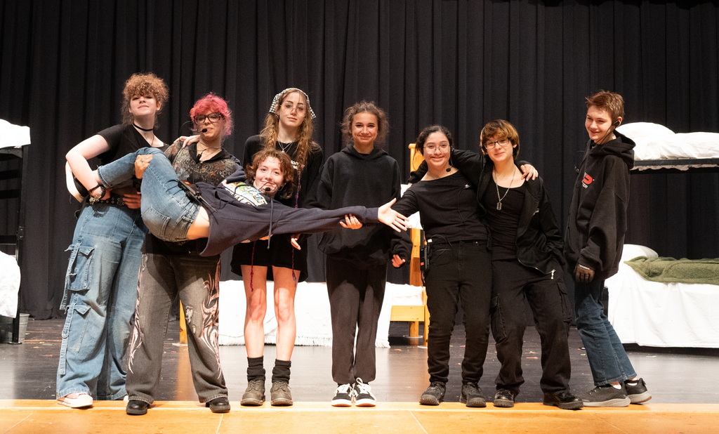 group of people dressed in balck posing for picture