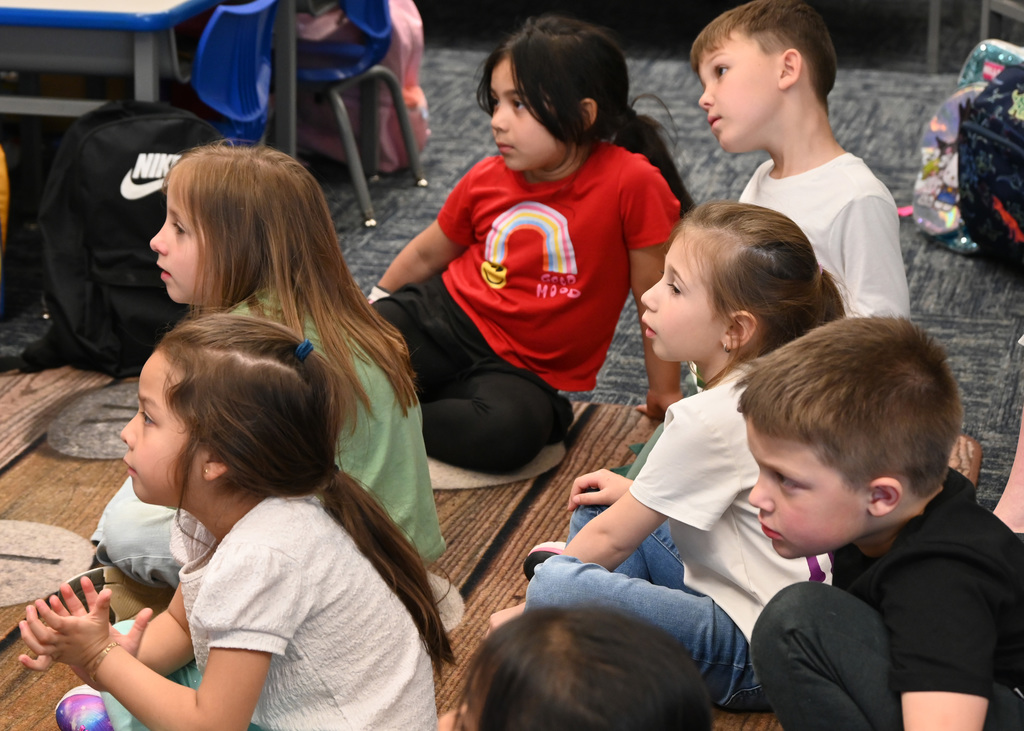 chidren sitting on floor listening to story