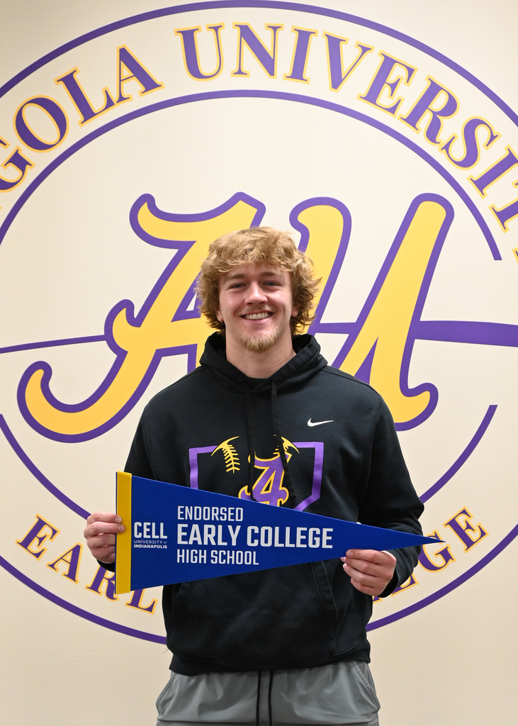 boy holding Early college banner standing in from of Angola University Logo