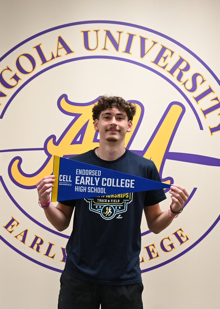 boy holding Early college banner standing in from of Angola University Logo