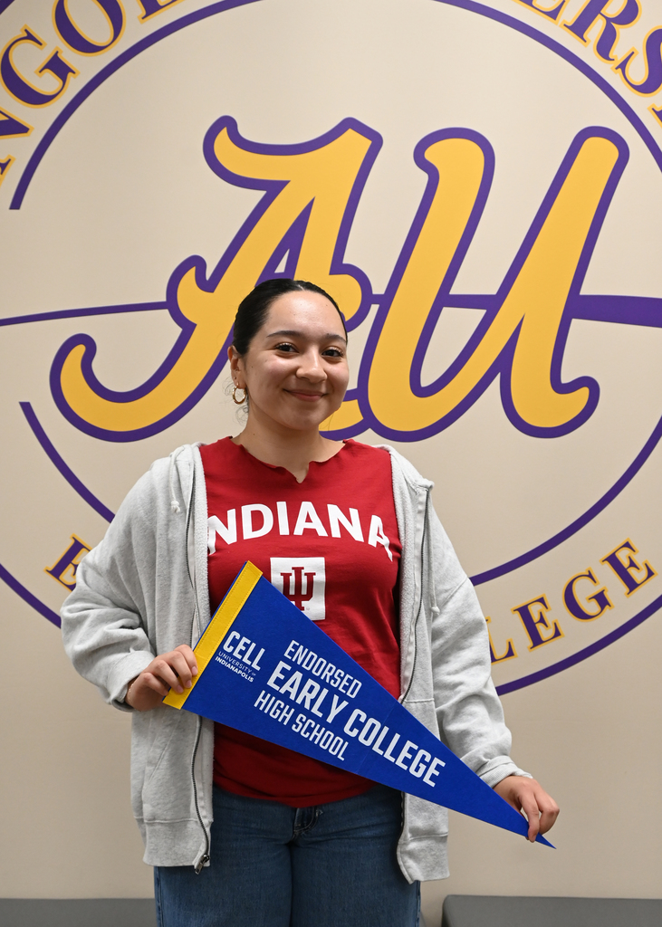 girl holding Early college banner standing in from of Angola University Logo