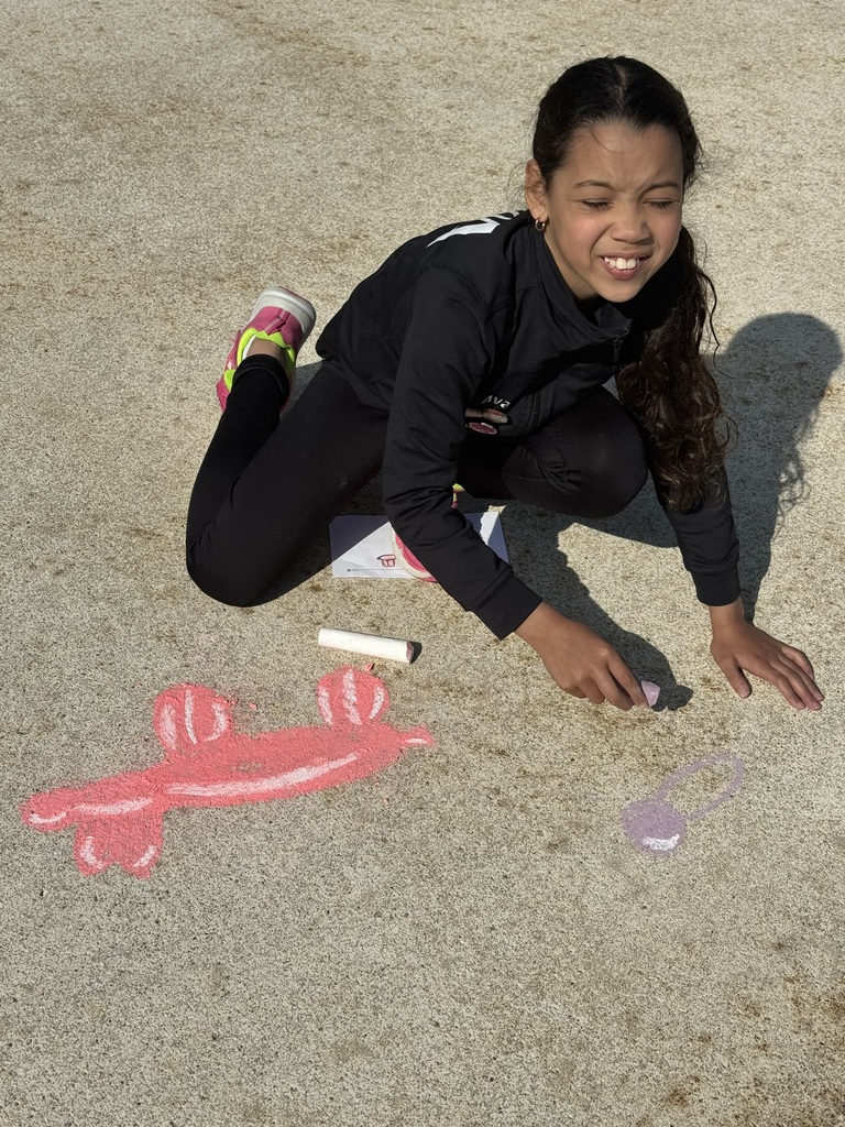 girl kneeling in from of chalk drawing