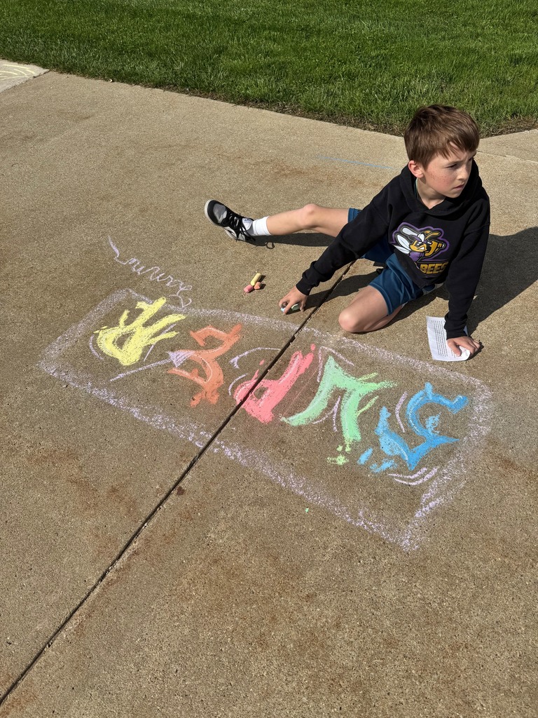boy kneeling in from of chalk drawing