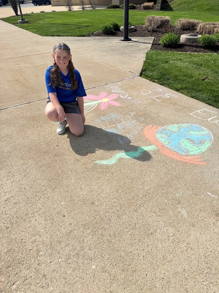 girl kneeling in from of chalk drawing