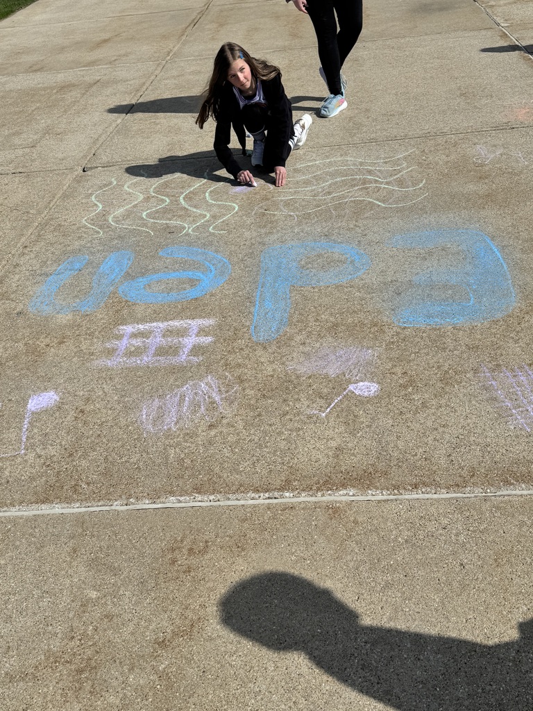 girl kneeling in from of chalk drawing