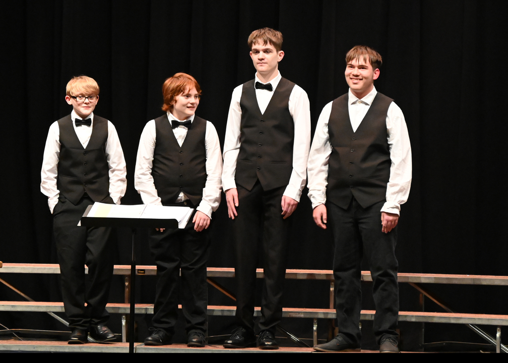 choir four boys dressed in black singing
