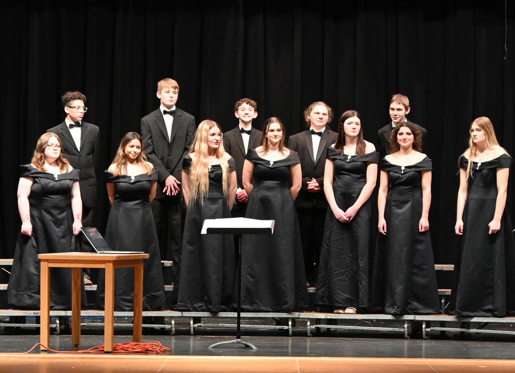 choir of girls and boys dressed in black singing