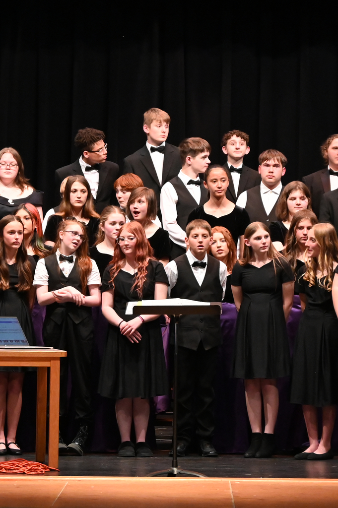choir of girl and boys dressed in black singing