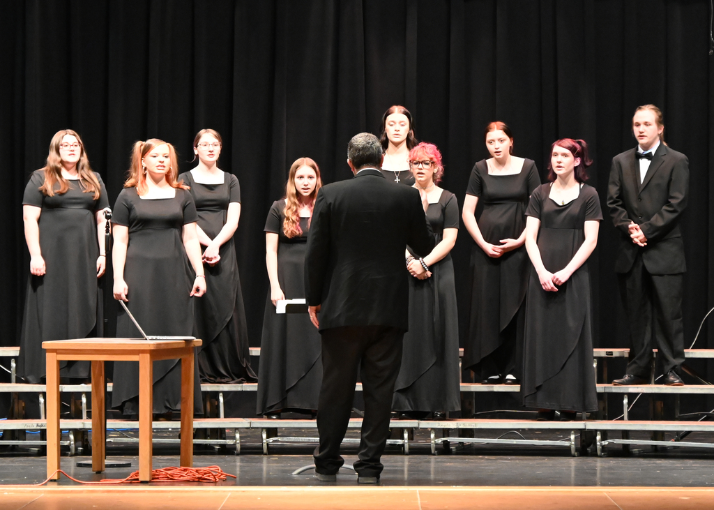 choir of girls dressed in black singing