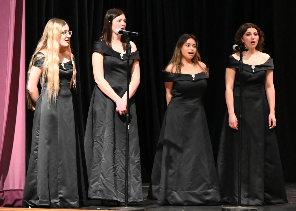 choir of  4girl  dressed in black singing