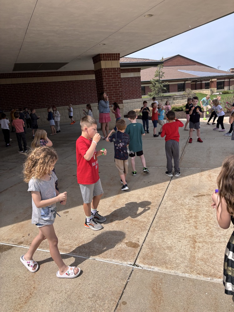 Children blowing bubbles outsitde
