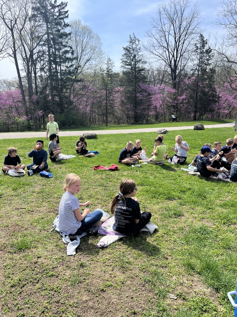 Children sitting outside eating lunch 