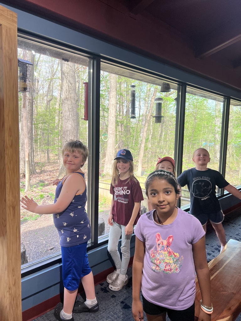 Children standing in front of window looking at camera