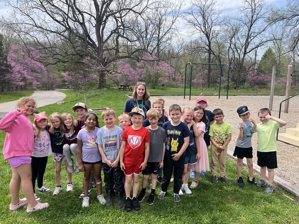 children standing in a group outside posing for a picture